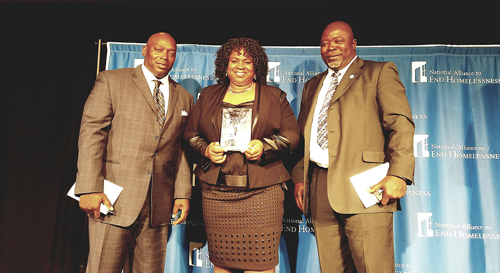 PHOTO CAPTION: (left to right) Catholic Charities’ Rapid Rehousing staff accept national award: Will Nance, Housing Locator, Jackie Edwards, Director of Community Services, and Mosudi Idowu, Rapid Rehousing Director.