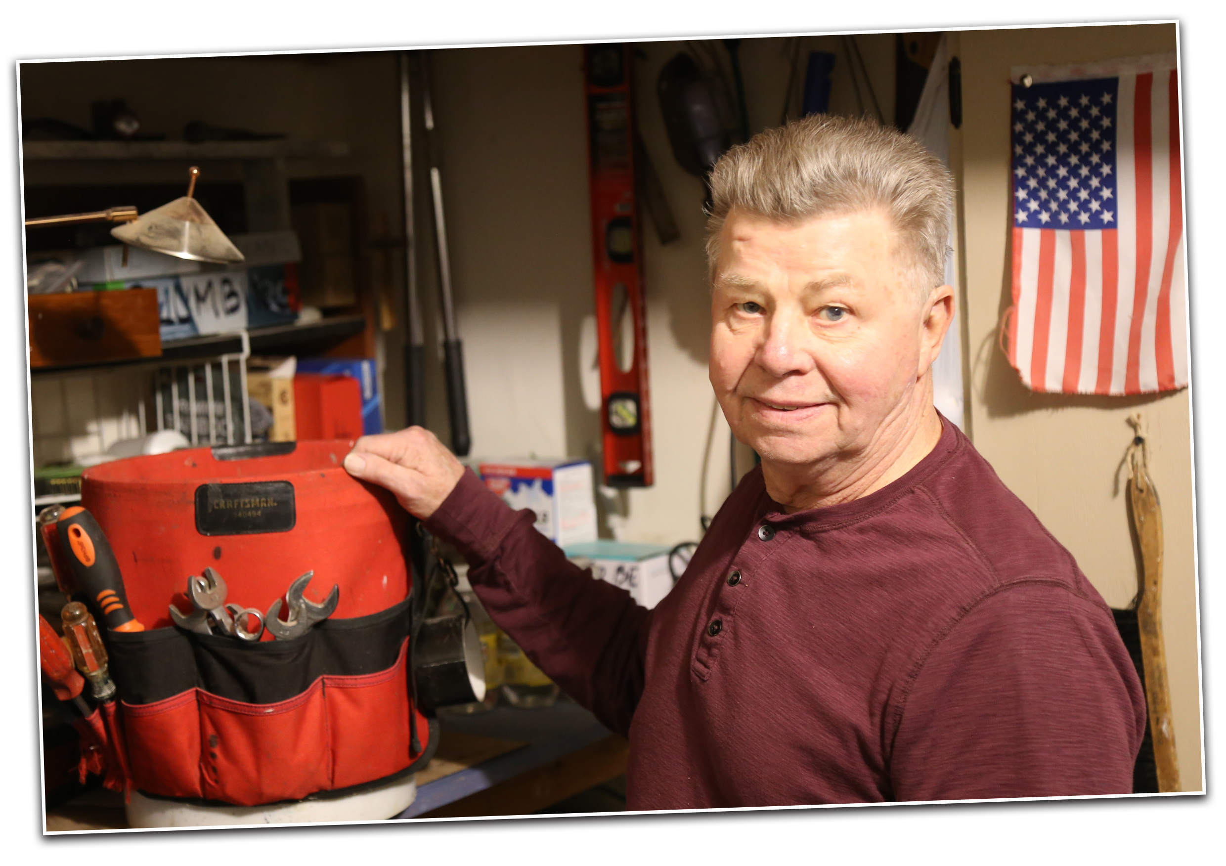 A older man organizing a bucket of tools.