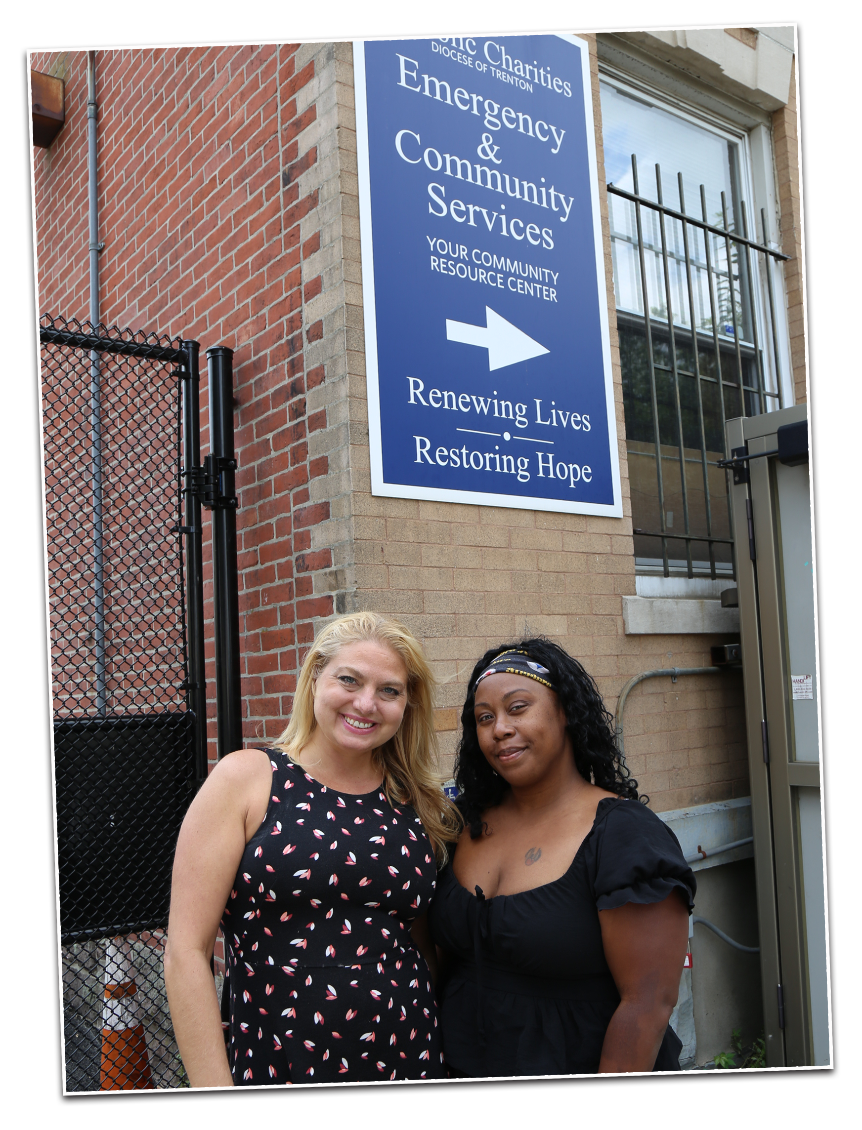 Two young women standing in front of the Community Services building on Warren Street in Trenton 