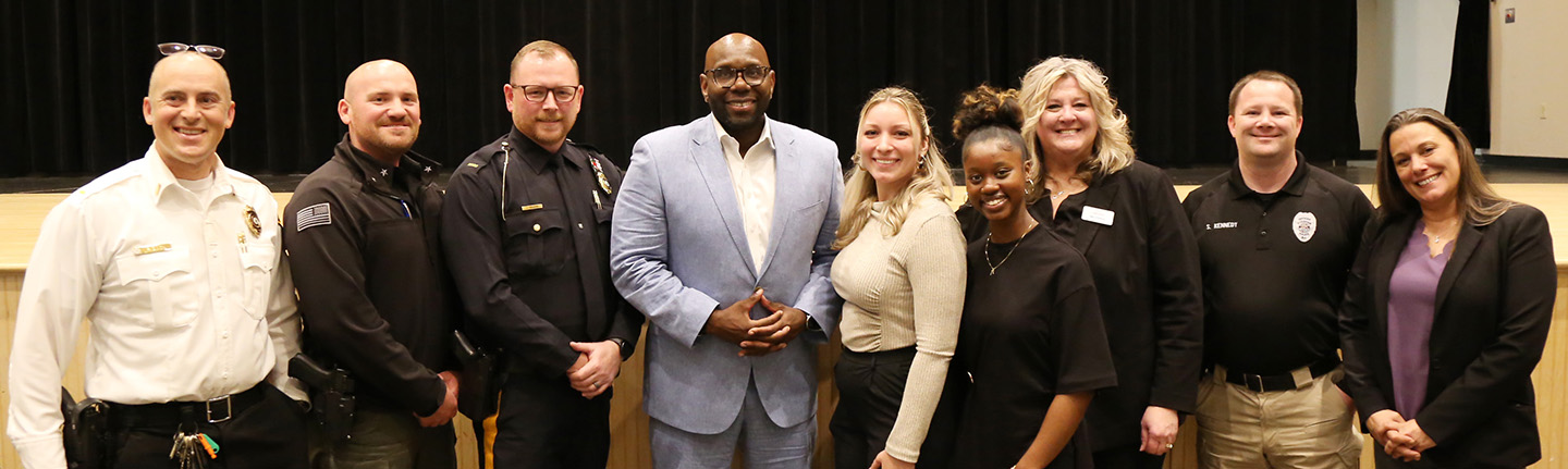 Senator Troy Singleton standing with police officers and employees of Providence Houe Domestic Violence Services